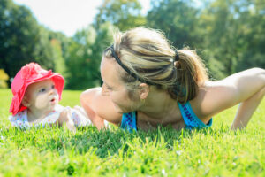 mother training with baby on a summer day