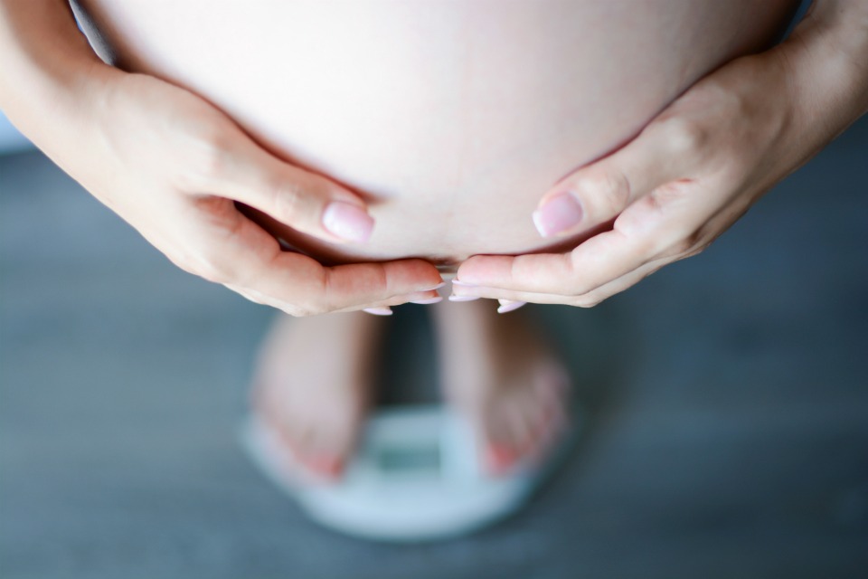 pregnant woman on scales