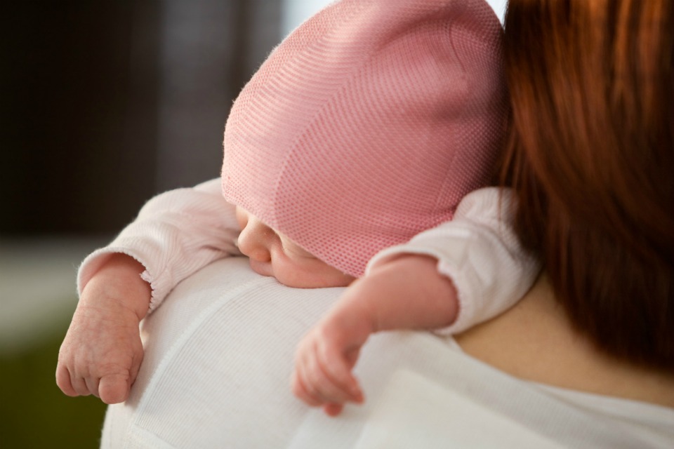 Mother holding newborn baby girl