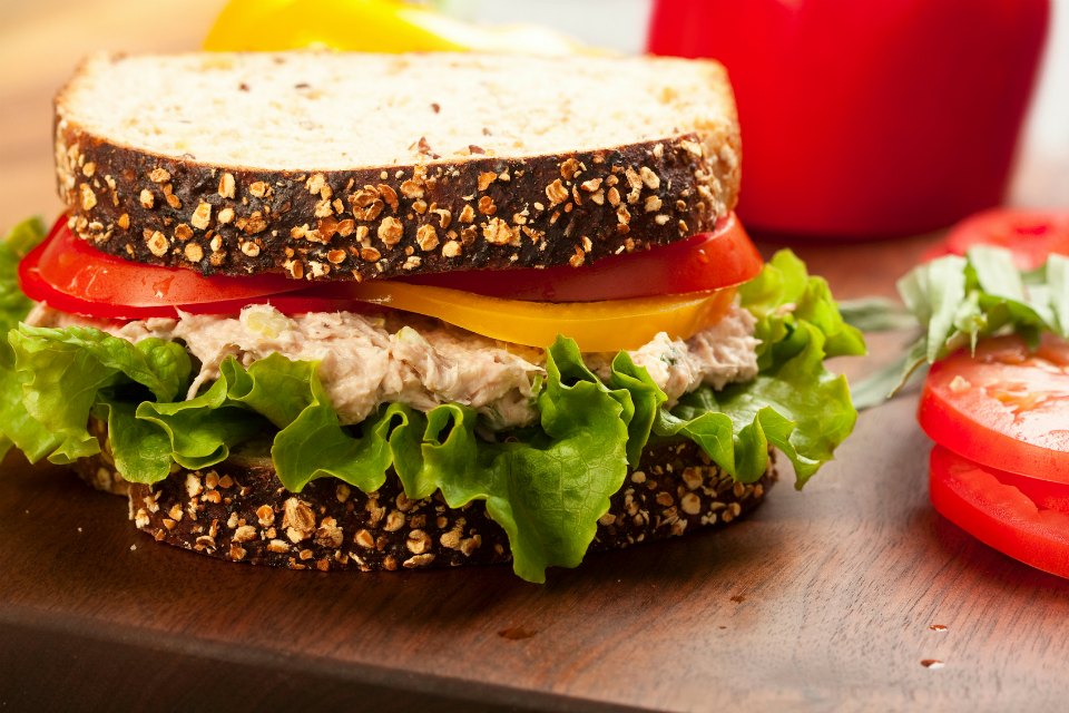 Tuna fish sandwich on multigrain bread with lettuce and tomato