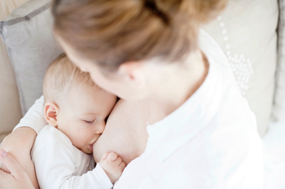 Young-mother-breastfeeding-the-newborm-baby--indoors