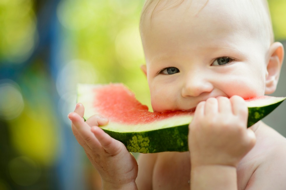 baby eating watermelon