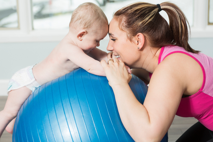 Mother with child boy doing fitness exercises