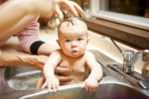 Baby Bathing In Sink