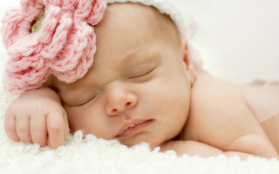 newborn with flower on head