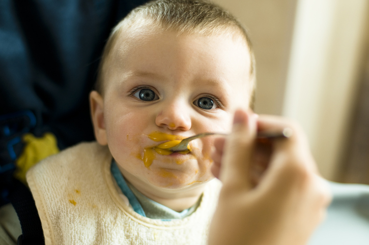 little sweet baby is eating baby food