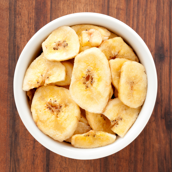 Top view of white bowl full of dried banana slices Related lightboxes: [url=http://www.istockphoto.com/search/lightbox/10859422]- FOOD SQUARE ONE[/url]