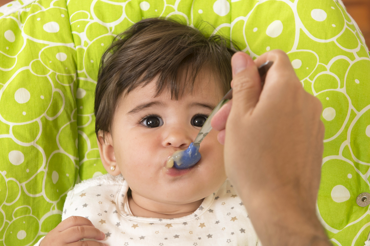 hand with spoon Feeding cute Lovely Baby Girl