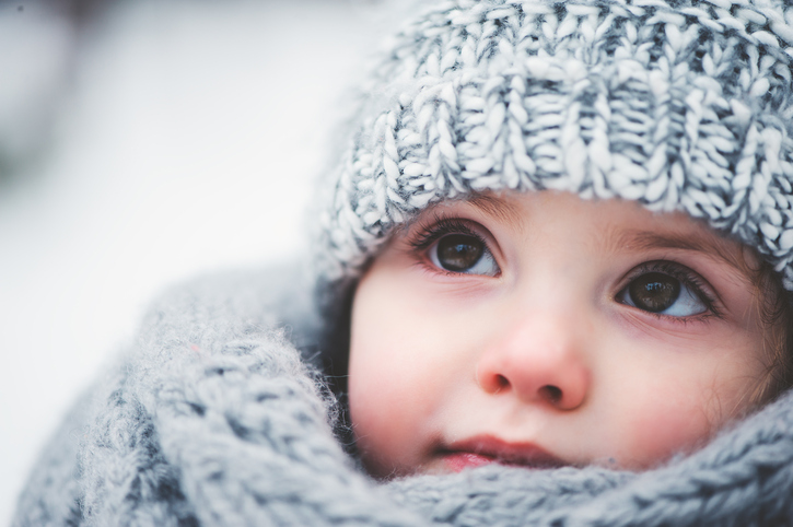 dreamy cozy outdoor portrait of toddler child girl in winter