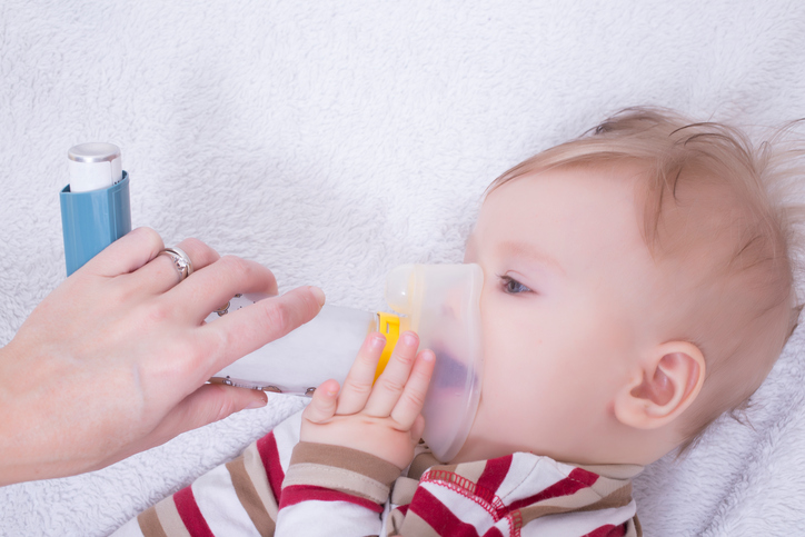 Infant with asthma inhalator