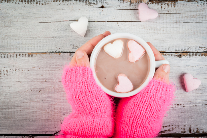 Girl drinking hot chocolate with marshmallows's hearts