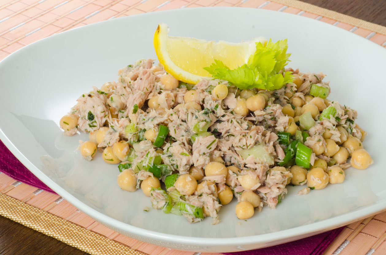 Close up on a dish of chickpea salad with tuna and herbs