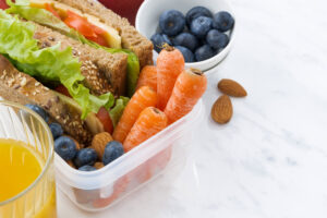 lunch box with sandwich of wholemeal bread on white background