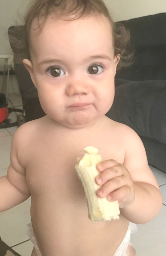 child eating banana