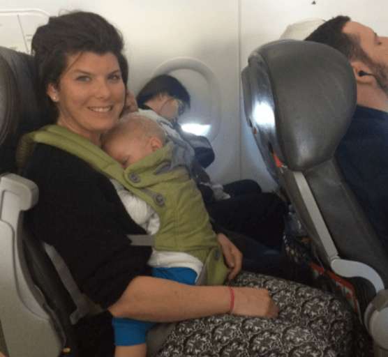 Mum holding baby on lap in plane 