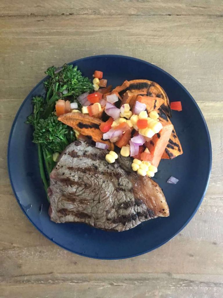 Grilled steak with sweet potato wedges and salsa