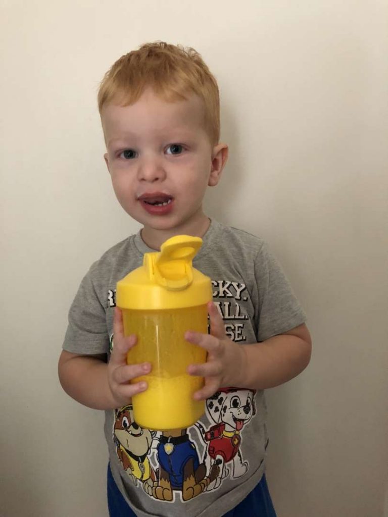 Little boy holding smoothie