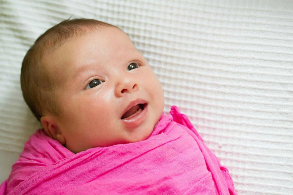 newborn in pink wrap