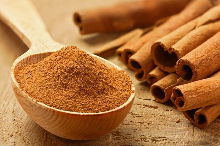 Cinnamon sticks and powder, studio shot, wood background,