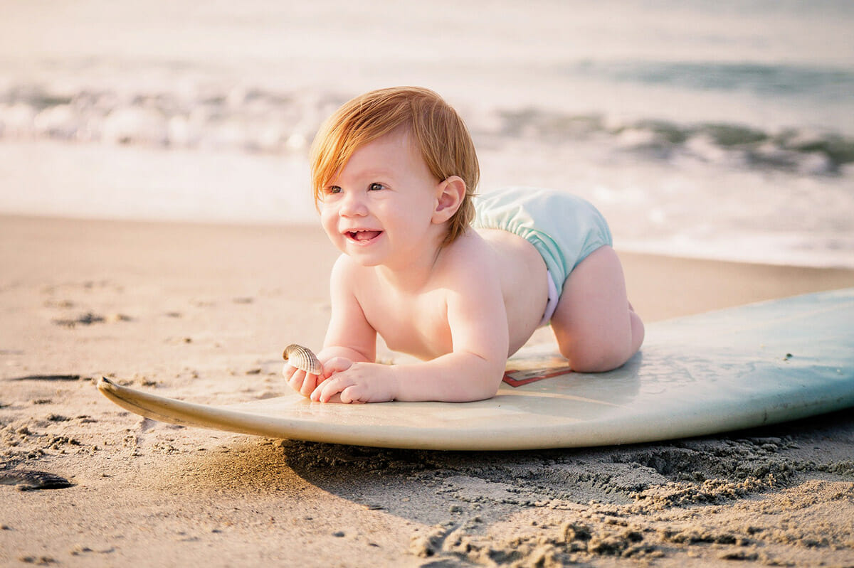 Surfing baby on the beach