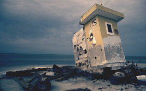 decaying seaside home crumbling into sea