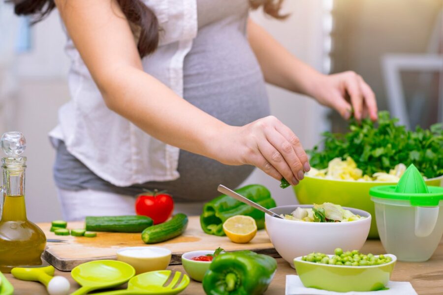 pregnant-woman-cooking-healthy-pregnancy-food-with-high-folate