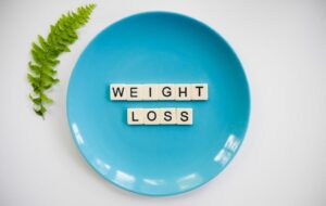 Weight loss on a blue plate spelt with scrabble letters